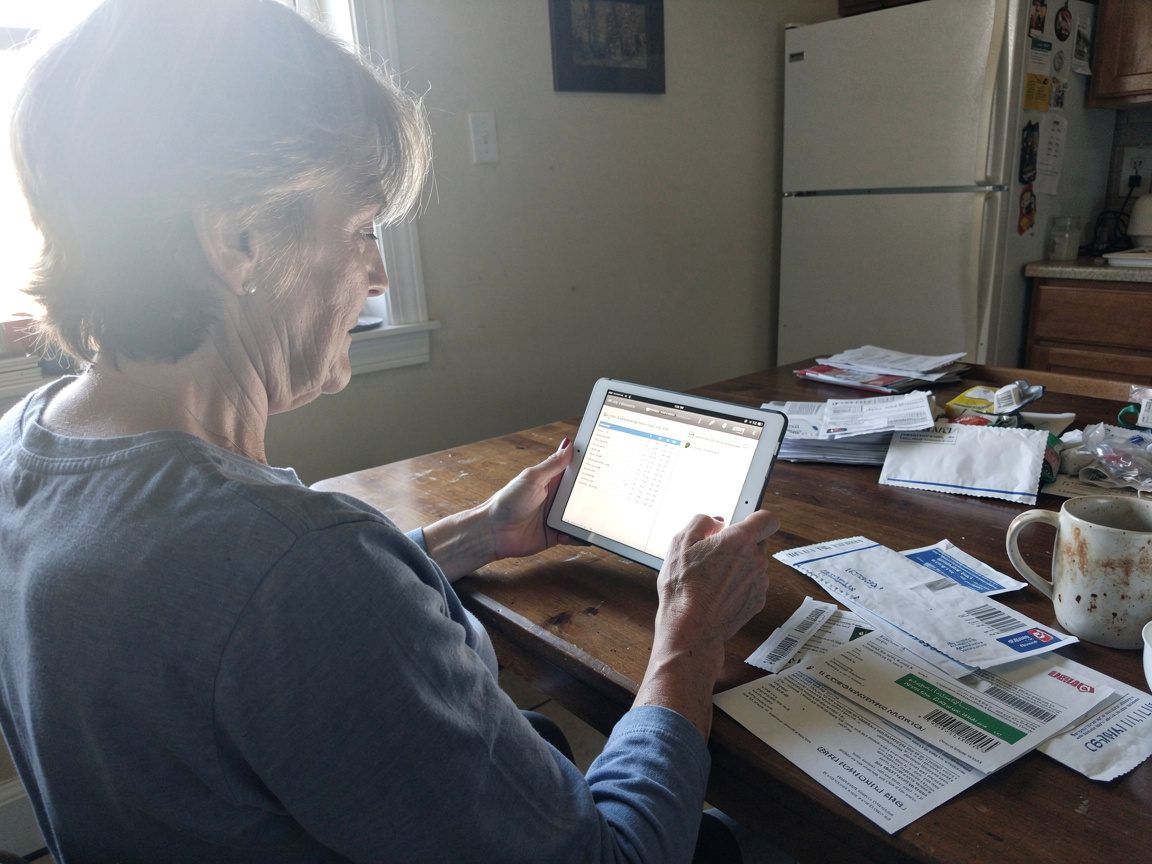 A homeowner browsing a landscaping company website on a tablet at home