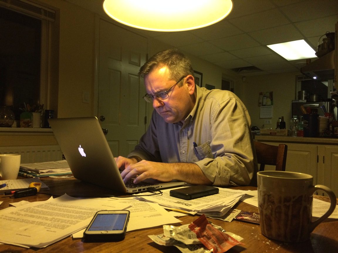 A landscaping business owner frustrated with a slow, outdated website in the evening